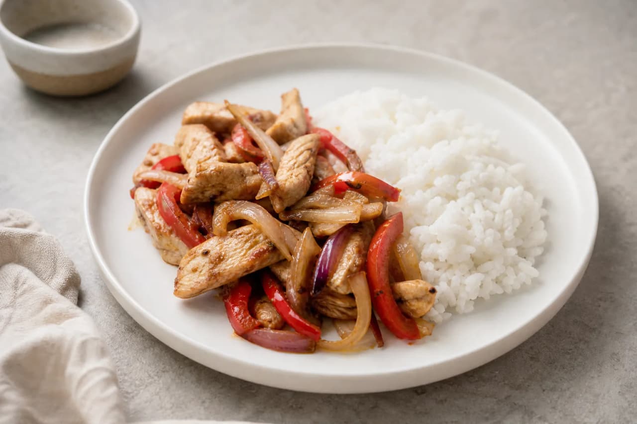Hähnchenpfanne mit Paprika und Reis, angerichtet